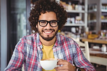 Fototapeta na wymiar Portrait of man smiling while having coffee
