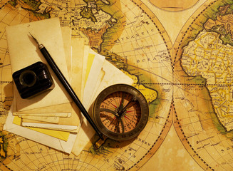 Compass and letters over map