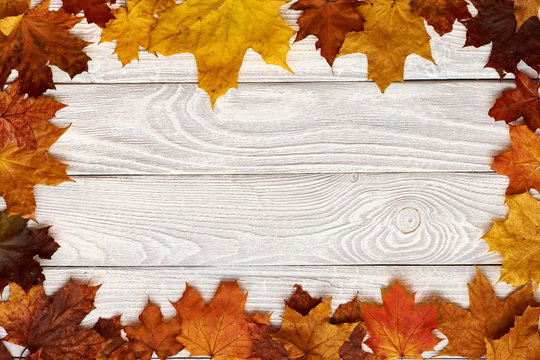Wooden background with autumn leaves