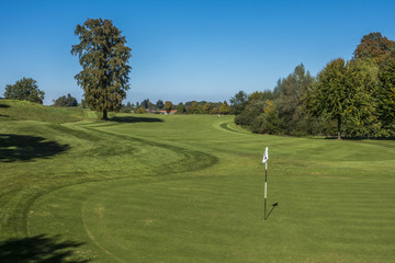 Loch mit Flaggenstock auf einem Golfplatz