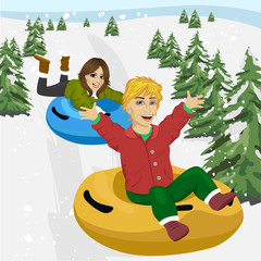 group of happy friends sliding down on snow tubes - winter, leisure, friendship and people concept