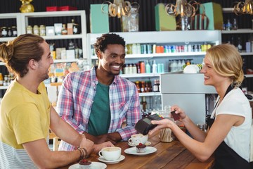 Waitress handing credit card machine to customer
