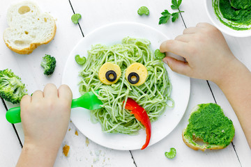 Pasta with green vegetables pesto shaped cute monster © san_ta