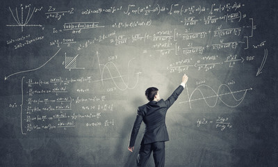 Man writing on blackboard