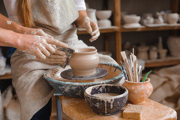 Fototapeta na wymiar Potter teaches how make clay pot
