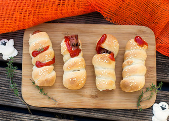 Halloween sausage rolls mummies with fake ketchup blood