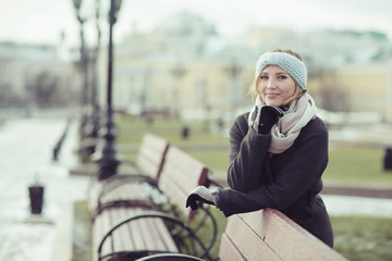 Fototapeta premium Dreaming woman in winter city a festive mood