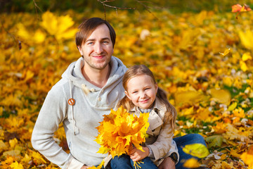 Father and daughter outdoors at autumn day