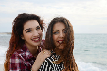 gossip girls smiling on the beach
