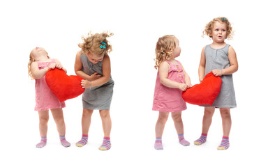 Couple of young little girls standing over isolated white background