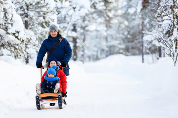 Fototapeta na wymiar Father and kids outdoors on winter