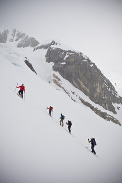 A group of people ski touring in the Canadian Rockies backcountry. Icefall Lodge, British Columbia, Canada