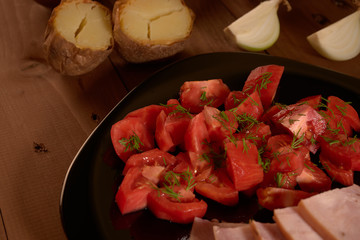 baked potatoes and a salad of tomatoes