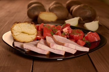baked potatoes and a salad of tomatoes