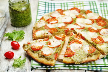 tomato mozzarella kale pesto pizza