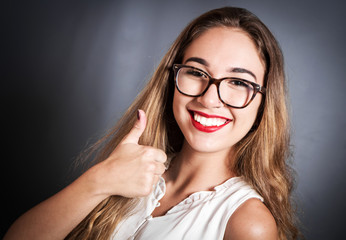 Young  girl with long hair showing thumbs up