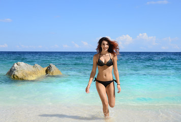 Fototapeta premium woman with perfect slim body running in the sea