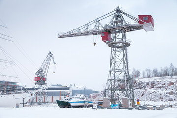 Fototapeta premium Cranes and cargo ships in wnter port