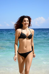 woman with perfect slim body running in the sea