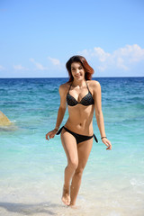 woman with perfect slim body running in the sea