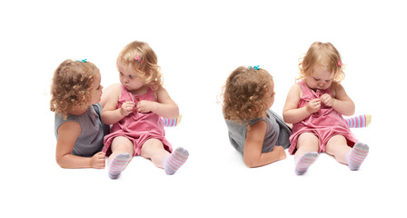 Couple of young little girl sitting over isolated white background