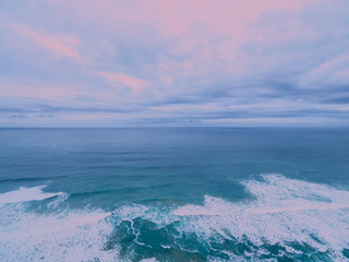 Fototapeta na wymiar Aerial view of ocean surf at sunrise