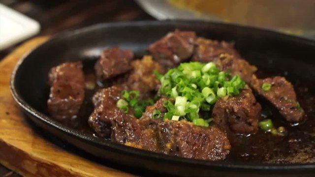 Japanese harami beef steak cut on sizzling pan in Izakaya restaurant style 