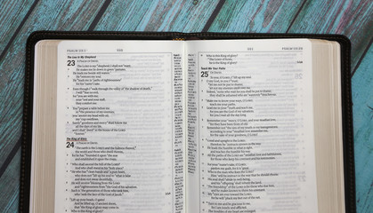 An Opened Bible on a Turquoise Distressed Wooden Table