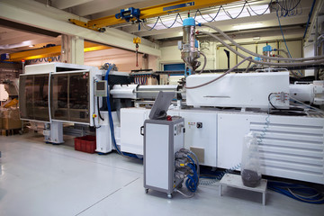 Injection molding machines in a large factory - obrazy, fototapety, plakaty