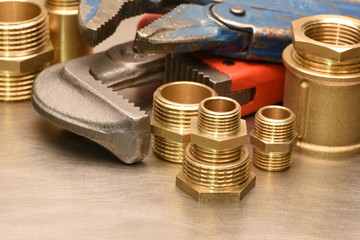 Wrench and brass fittings closeup