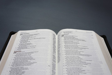 An Opened Bible on a Dark Chalkboard Surface