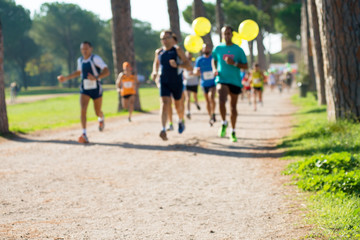 runners in marathon in a park abstract, blurry
