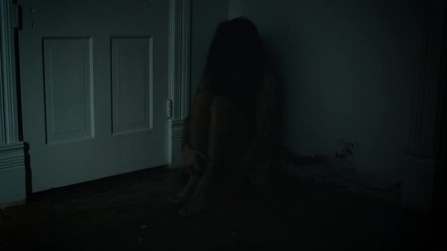 Possessed Girl Sitting in the Corner going Crazy