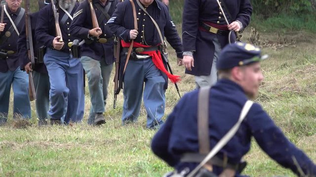 Civil War soldiers marching across field