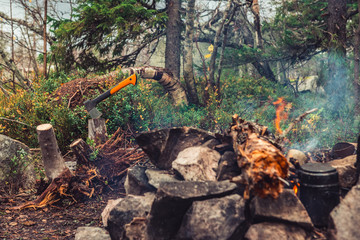 The axe stuck in the log near the bonfire