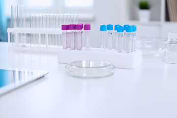 Research laboratory working space. Test tubes and tablet PC are lying at the table. Medical equipment. Blood test