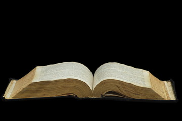 Big open book isolated on a black background