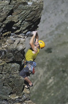 A young man climbing  the Cardiac Arete on the Grand Sentinel, Alberta, Canada.