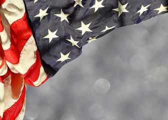 Rippled american flag corner curtain against blurred sparkling background with space for copy