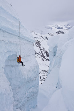 A man practicing crevasse rescue skills while on a ski mountaineering course, Ice fall Lodge, Golden, British Columbia, Canada
