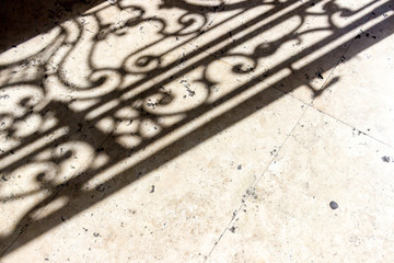 Gate shadow on the ground