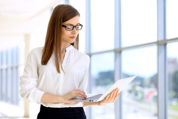 Portrait of modern business woman  working with laptop computer in the office, copy space area