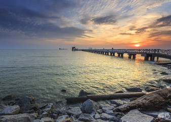 Fototapeta na wymiar Gorgeous sunset over the sea and a jetty in the tropical paradise