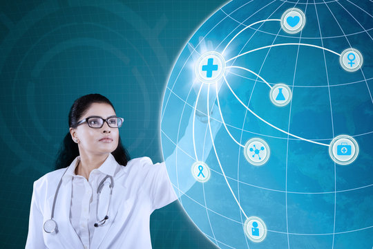 Indian doctor pressing medical icon - Powered by Adobe