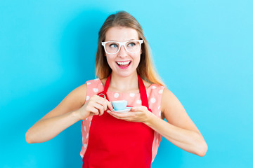 Happy young woman drinking coffee