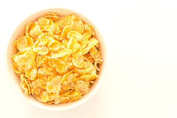 Cornflakes in a bowl, isolated on white background, Top view with copy space.