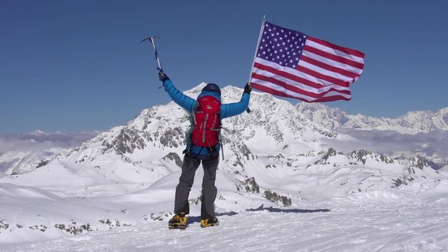 American mountaineer celebrates on mountain peaks.