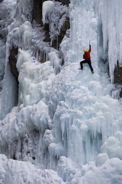A male ice clmber tackles some steep ice in Johnstone  Canyon, Banff National Park, AB