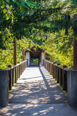 Covered walking bridge in wooded tranquil serene peaceful setting