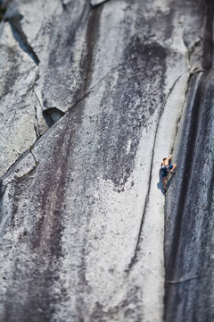 A strong male climber climbing Crescent Crack 10d, Squamish, BC